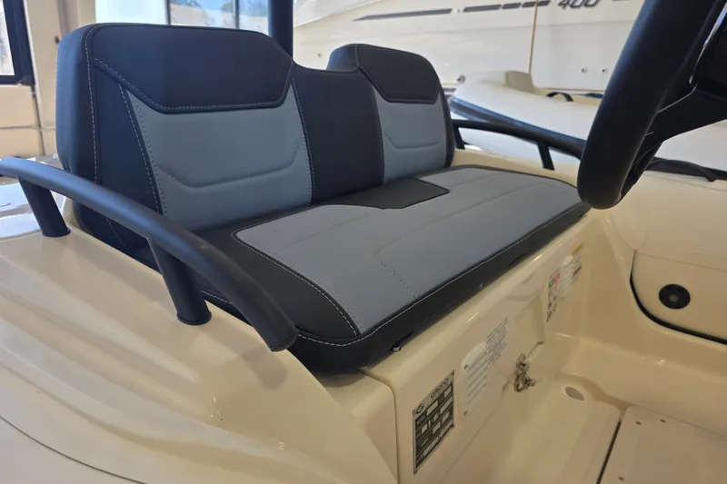 Slide: The Image of 2027 Grand Inflatables G420 boat seat with black and gray upholstery in a showroom. - 5