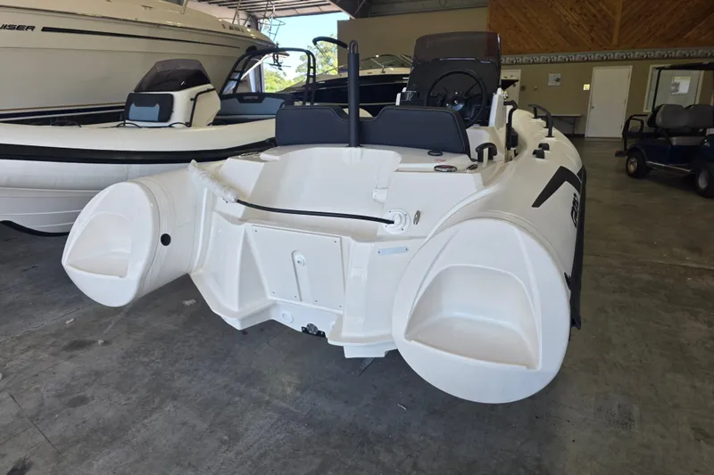 Slide: The Image of 2027 Grand Inflatables G420 boat in showroom, showcasing sleek design and modern features. - 8