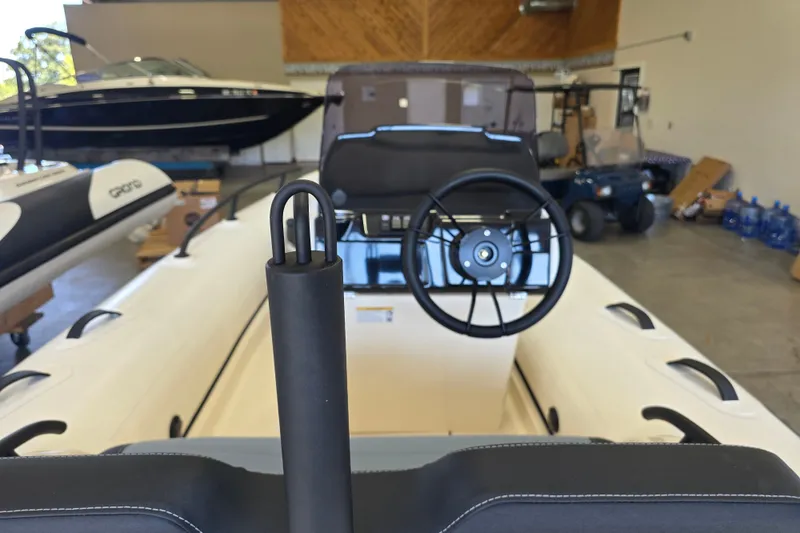 Slide: The Image of 2027 Grand Inflatables G420 boat interior with steering wheel in showroom. - 9
