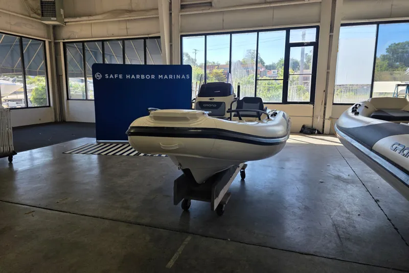 Slide: The Image of 2027 Grand Inflatables G420 boat displayed indoors at Safe Harbor Marinas. - 1