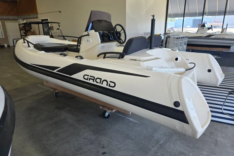 Slide: The Image of 2027 Grand Inflatables G420 boat displayed indoors, showcasing sleek design and modern features. - 12