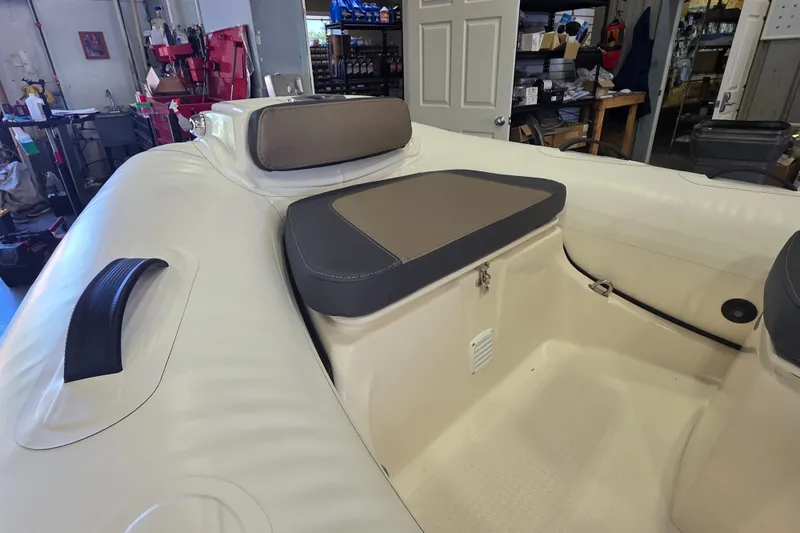Slide: The Image of Interior view of 2027 Grand Inflatables G380N boat, featuring cushioned seating and storage. - 6