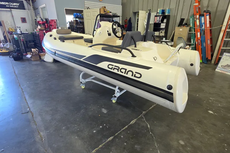Slide: The Image of 2027 Grand Inflatables G380N boat displayed in a showroom, featuring sleek design and modern features. - 4
