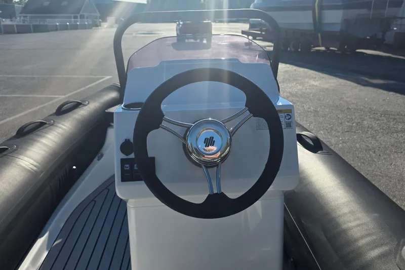 Slide: The Image of 2027 Grand Inflatables G380N steering console with sunlight reflection. - 8