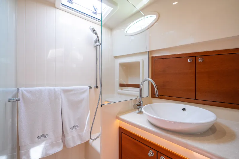 Slide: The Image of Luxurious bathroom in 2017 Palm Beach Motor Yachts PB42, featuring elegant wood cabinetry and modern fixtures. - 49