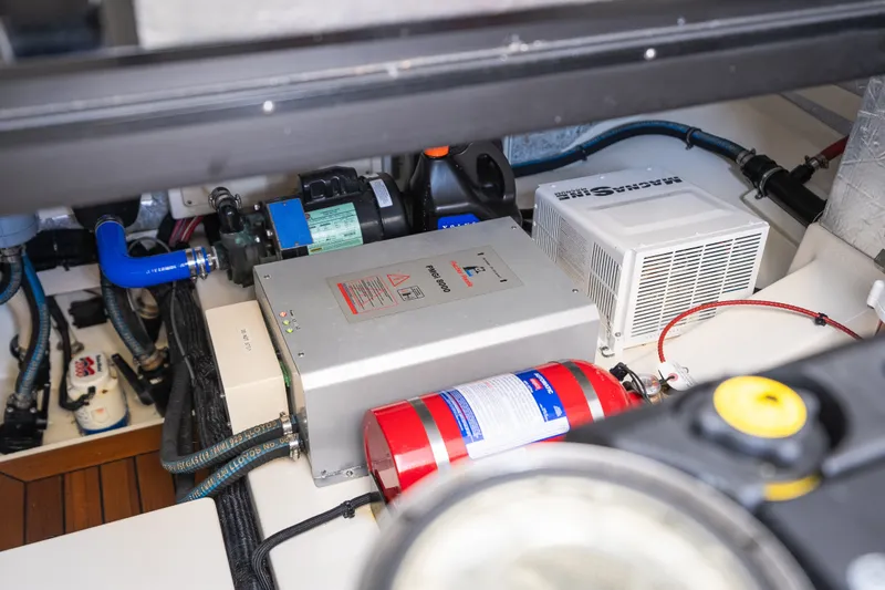 Slide: The Image of Engine room of 2017 Palm Beach Motor Yachts PB42 with mechanical components and fire extinguisher. - 55