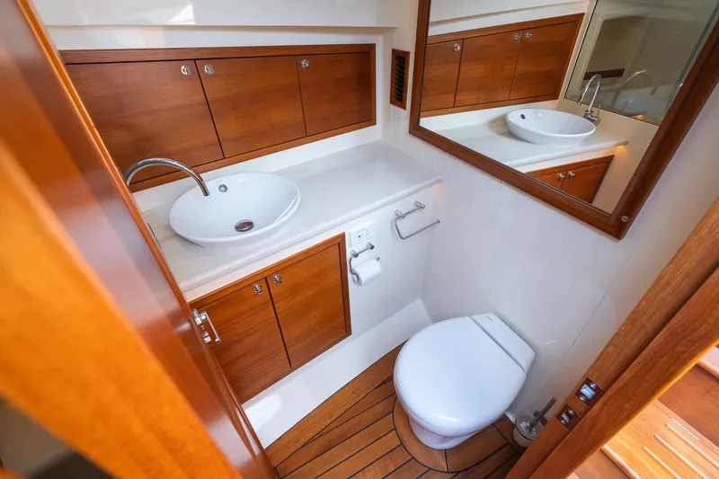 Slide: The Image of Luxurious 2017 Palm Beach Motor Yachts PB42 bathroom with wooden cabinetry and modern fixtures. - 48