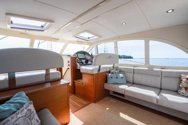 Slide: The Image of Luxurious interior of 2017 Palm Beach Motor Yachts PB42 with elegant seating and panoramic windows. - 29