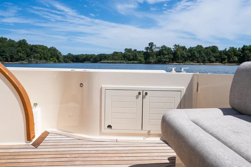 Slide: The Image of 2017 Palm Beach Motor Yachts PB42 deck with scenic water view and comfortable seating. - 18
