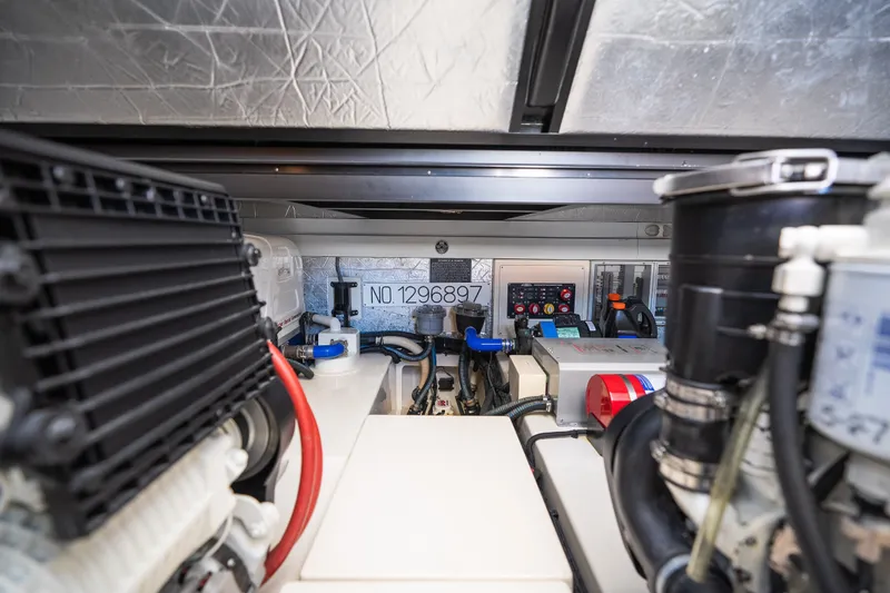 Slide: The Image of Engine room of 2017 Palm Beach Motor Yachts PB42, showcasing mechanical components and control panel. - 54