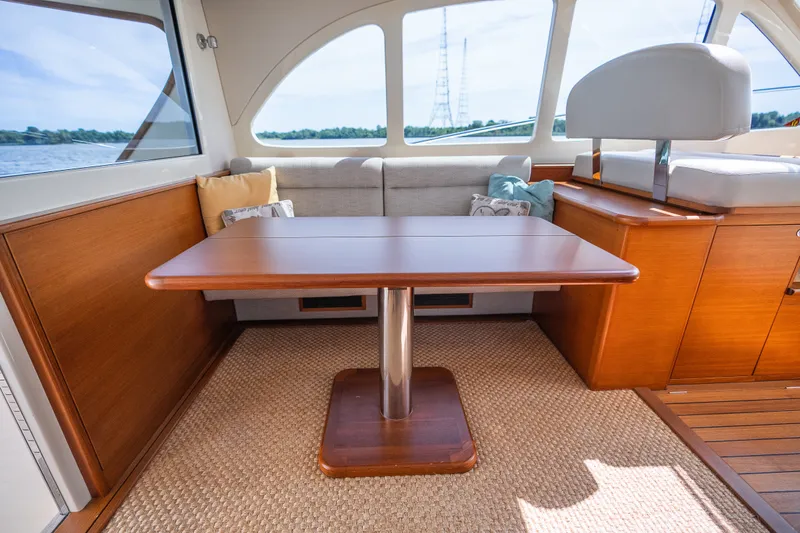 Slide: The Image of Luxurious interior of 2017 Palm Beach Motor Yachts PB42 with wooden table and seating. - 31
