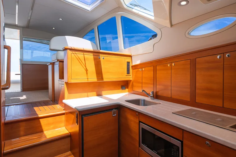 Slide: The Image of Luxurious interior of 2017 Palm Beach Motor Yachts PB42 with wood cabinetry and modern amenities. - 40