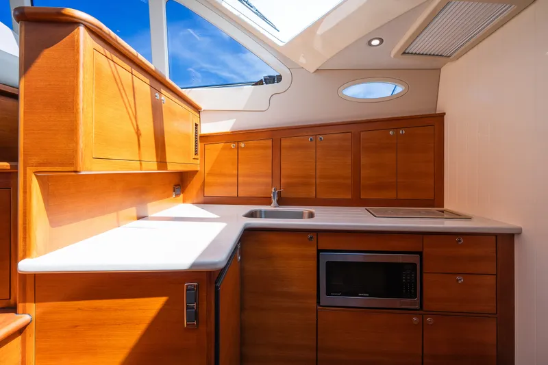 Slide: The Image of Luxurious 2017 Palm Beach Motor Yachts PB42 kitchen with wood cabinetry and modern appliances. - 41