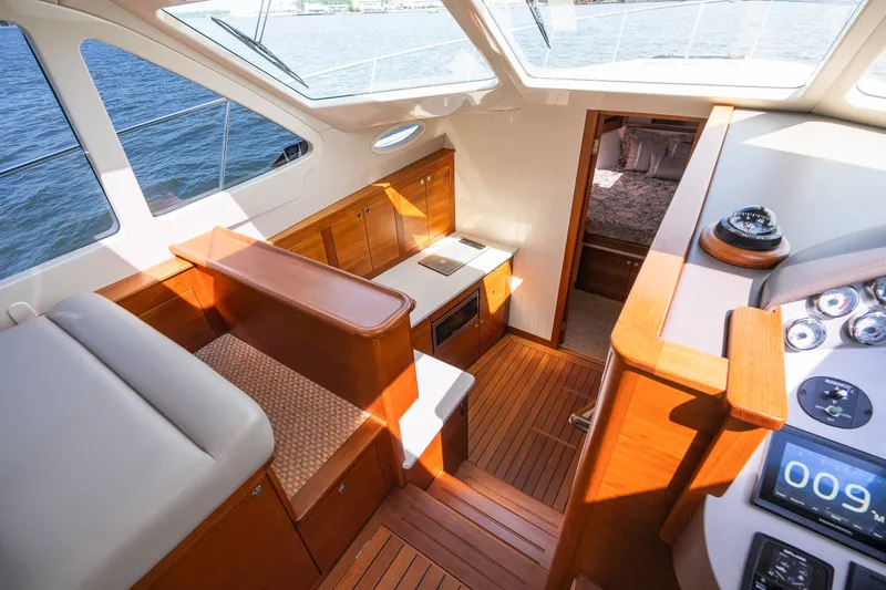 Slide: The Image of Luxurious interior of 2017 Palm Beach Motor Yachts PB42 with wood finishes and water view. - 38