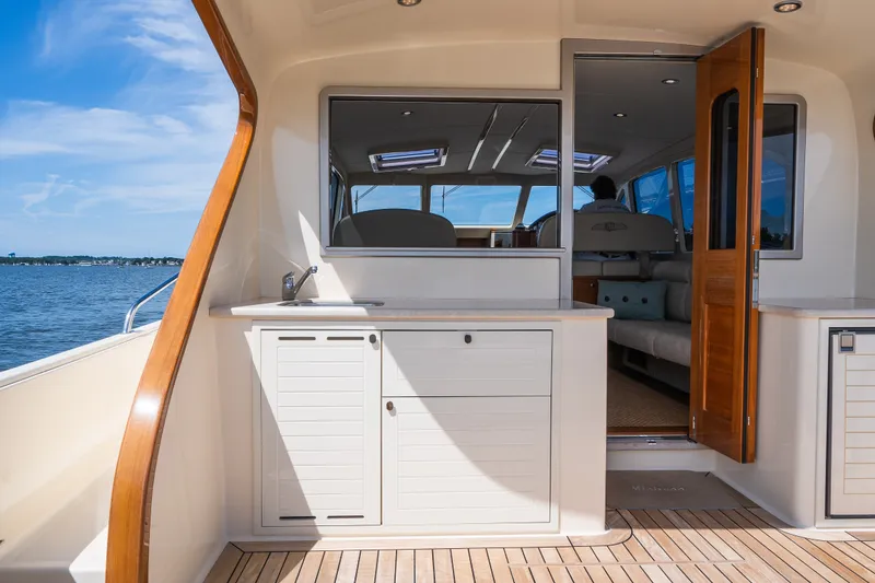 Slide: The Image of Luxurious 2017 Palm Beach Motor Yachts PB42 interior with elegant wood finishes and ocean view. - 11