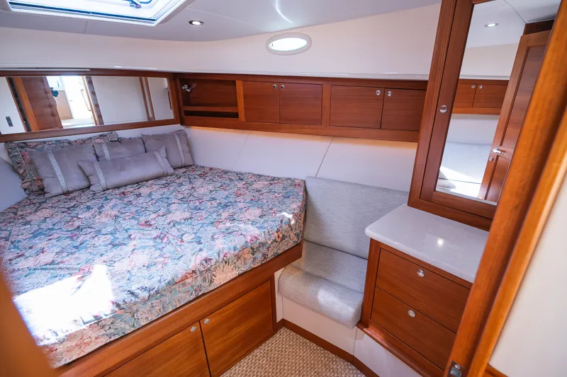 Slide: The Image of Luxurious cabin interior of 2017 Palm Beach Motor Yachts PB42 with wood finish and floral bedding. - 46