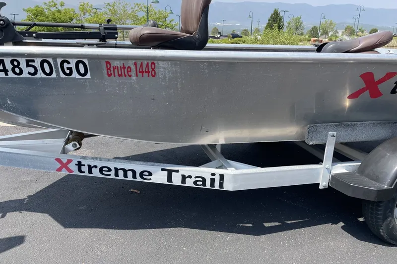 Slide: The Image of 2014 Extreme Boats Brute 1448T on Xtreme Trail trailer, parked outdoors. - 4