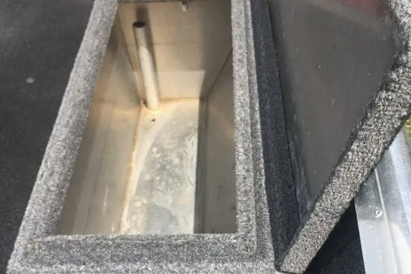 Slide: The Image of Open storage compartment in 2014 Extreme Boats Brute 1448T, featuring a carpeted interior. - 8