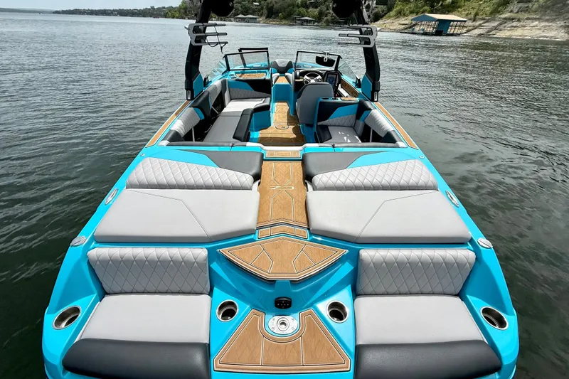 Slide: The Image of 2023 Tige Z3 boat with luxurious seating and sleek design on a calm lake. - 14