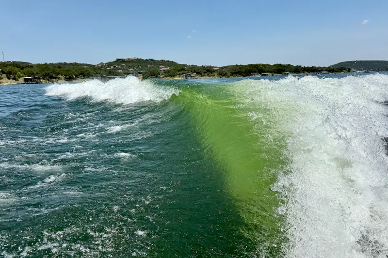 Slide: The Image of Waves created by a 2023 Tige Z3 boat on a sunny lake. - 37