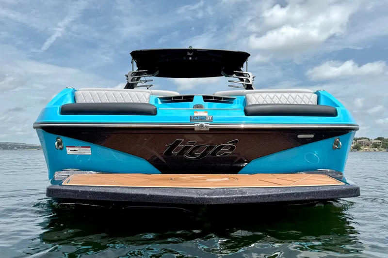 Slide: The Image of 2023 Tige Z3 boat on water, featuring sleek blue design and comfortable seating. - 5