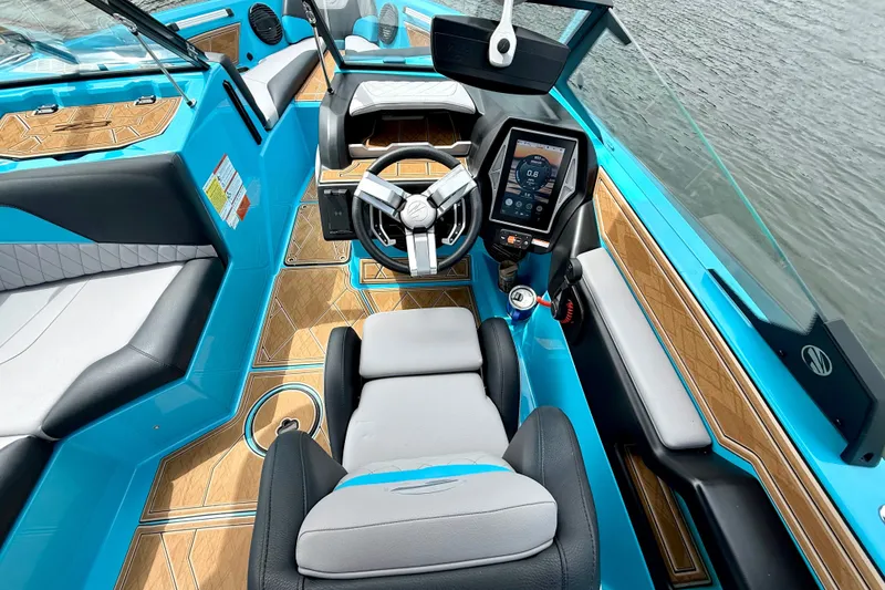 Slide: The Image of 2023 Tige Z3 boat interior with modern dashboard, blue accents, and wood flooring. - 19