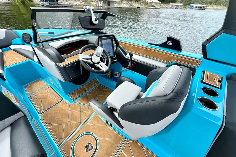 Slide: The Image of 2023 Tige Z3 boat interior with modern dashboard, blue accents, and wood-patterned flooring. - 18