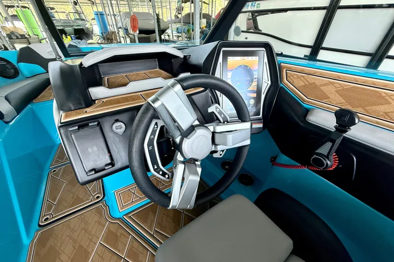 Slide: The Image of 2023 Tige Z3 boat interior with modern steering wheel and touchscreen display. - 29