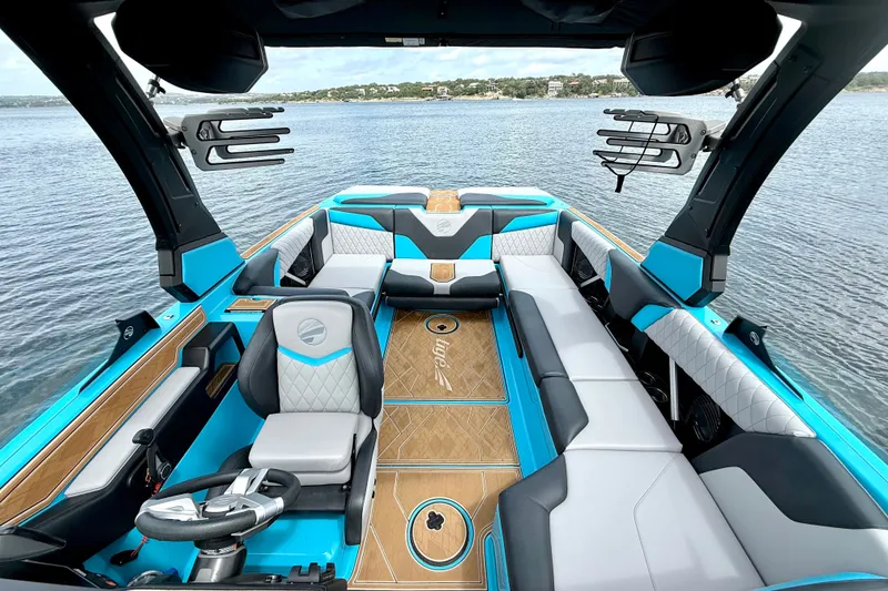 Slide: The Image of 2023 Tige Z3 boat interior with luxurious seating and modern design on a serene lake. - 15
