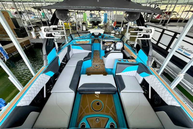 Slide: The Image of 2023 Tige Z3 boat interior with modern seating and sleek design in a marina setting. - 28