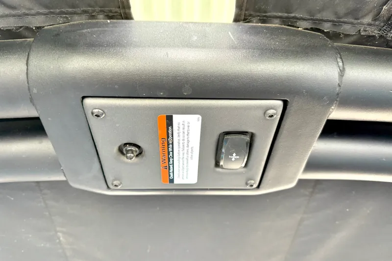 Slide: The Image of Control panel of 2023 Tige Z3 boat with warning label and toggle switch. - 21
