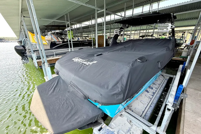 Slide: The Image of 2023 Tige Z3 boat covered and docked in a marina. - 36