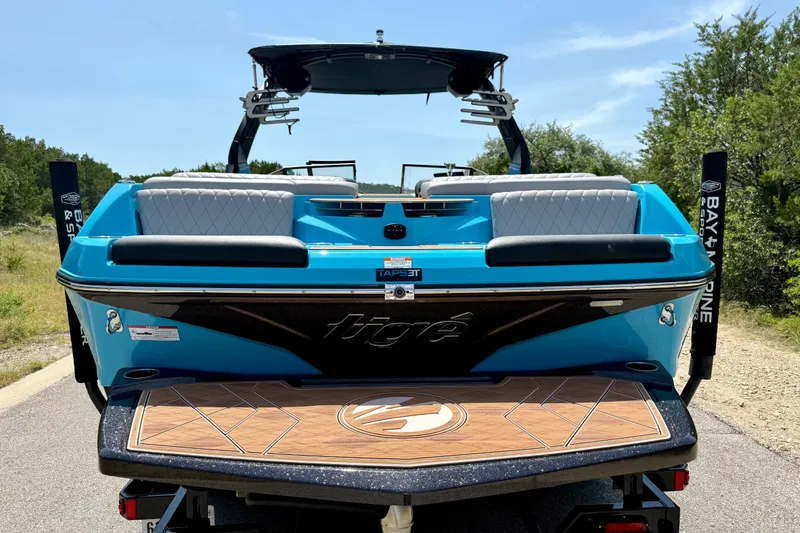 Slide: The Image of 2023 Tige Z3 boat, blue exterior, rear view with seating and swim platform. - 9