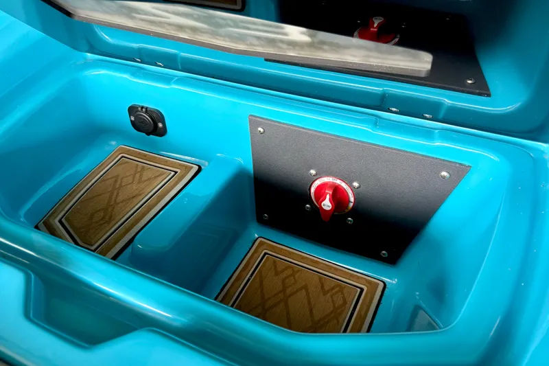 Slide: The Image of 2023 Tige Z3 boat interior storage compartment with blue finish and control panel. - 23