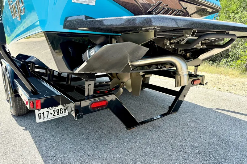 Slide: The Image of Rear view of a 2023 Tige Z3 boat on a trailer, showcasing the propeller and exhaust system. - 10