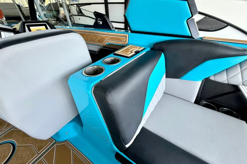 Slide: The Image of 2023 Tige Z3 boat interior with blue and black seating, featuring cup holders. - 34