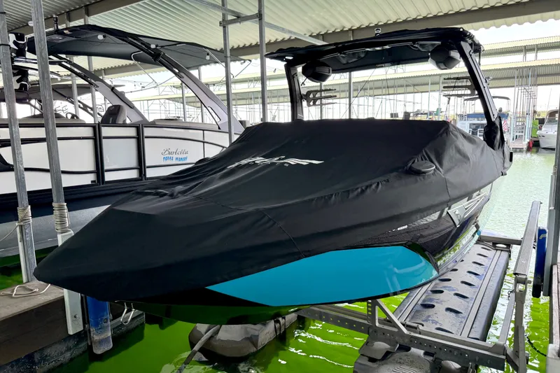 Slide: The Image of 2023 Tige Z3 boat covered in black tarp, docked in a marina. - 35