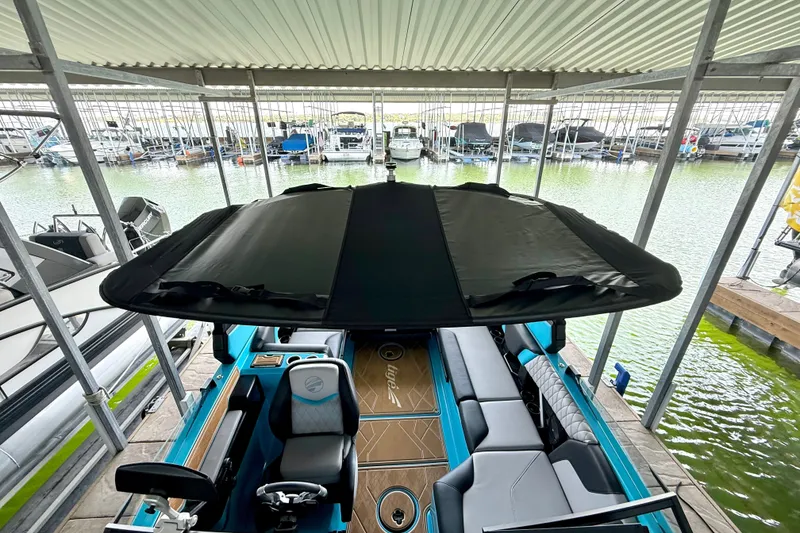 Slide: The Image of 2023 Tige Z3 boat with canopy, docked in a marina. - 30