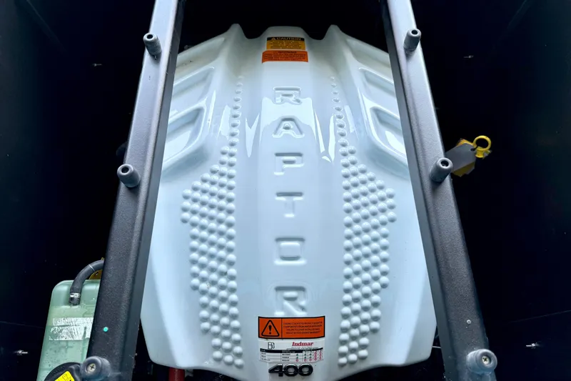 Slide: The Image of 2023 Tige Z3 Raptor engine cover with textured design and warning labels. - 32