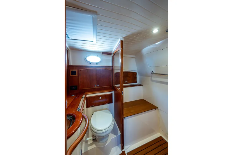 Slide: The Image of Luxurious bathroom interior of 2020 Hinckley Picnic Boat 40 with wooden accents. - 26
