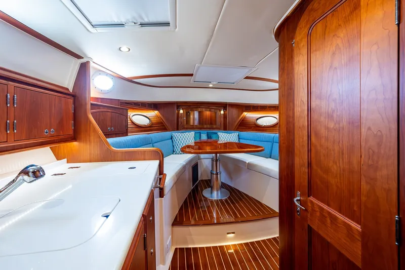 Slide: The Image of Luxurious interior of 2020 Hinckley Picnic Boat 40 with elegant wood finish and seating area. - 21