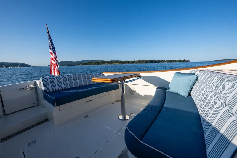 Slide: The Image of Hinckley Picnic Boat 40, 2020 model, with elegant seating and scenic water view. - 14