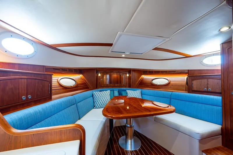 Slide: The Image of Luxurious interior of 2020 Hinckley Picnic Boat 40 with elegant wood and blue seating. - 24