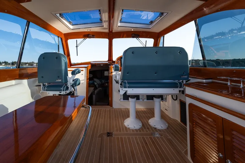Slide: The Image of Interior of 2020 Hinckley Picnic Boat 40, featuring elegant seating and wooden finishes. - 17