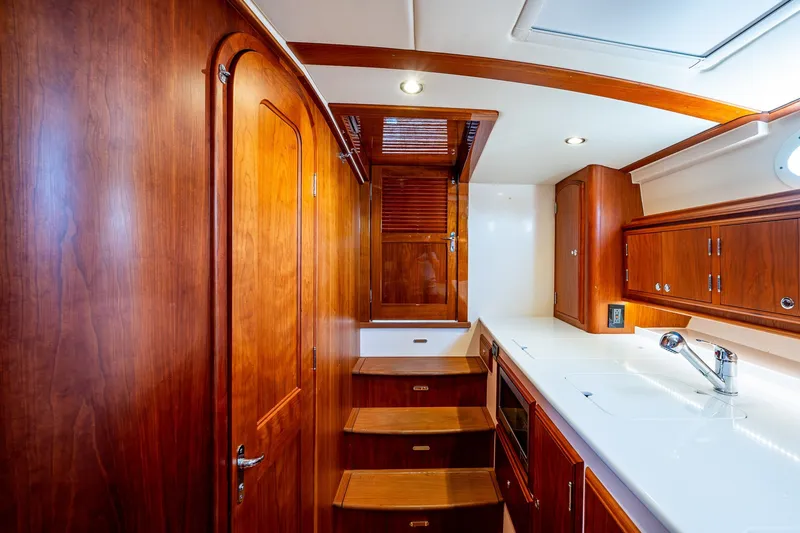 Slide: The Image of Luxurious wooden interior of 2020 Hinckley Picnic Boat 40 galley with modern amenities. - 22
