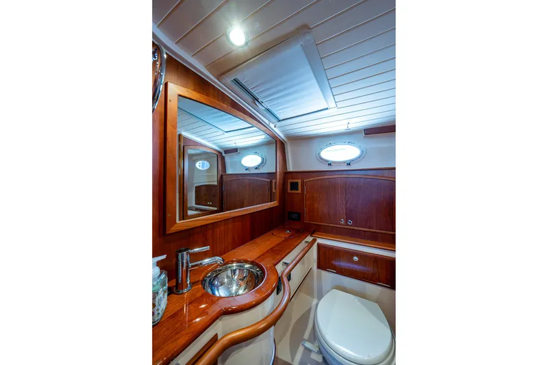 Slide: The Image of Luxurious bathroom interior of 2020 Hinckley Picnic Boat 40 with wooden cabinetry and modern fixtures. - 25