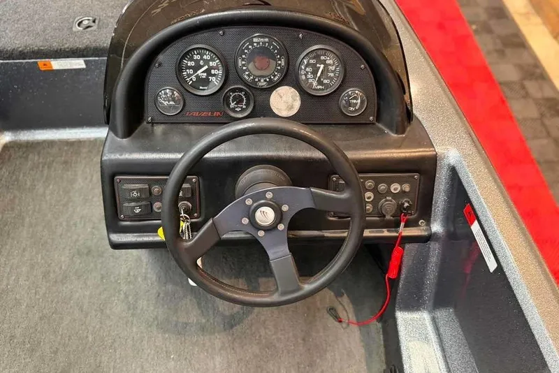 Slide: The Image of Dashboard of a 1999 Javelin RENEGADE 18 boat with steering wheel and gauges. - 6