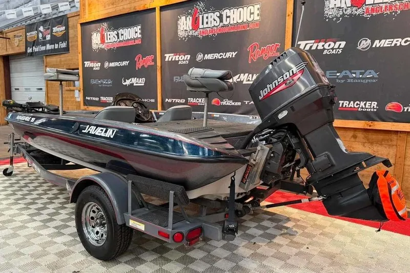 Slide: The Image of 1999 Javelin RENEGADE 18 boat with Johnson motor on display indoors. - 3