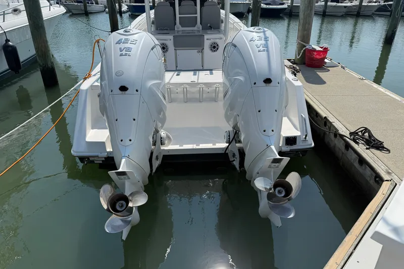 Slide: The Image of 2022 Everglades 365 Center Console boat with twin outboard engines docked at marina. - 43