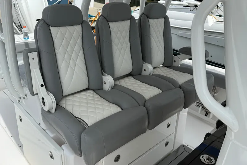 Slide: The Image of 2022 Everglades 365 Center Console boat seats with gray and white diamond stitching. - 21